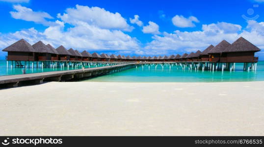 beach with water bungalows at Maldives