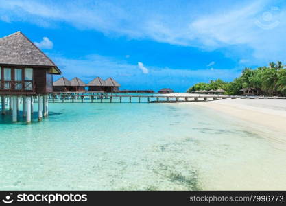 beach with water bungalows at Maldives