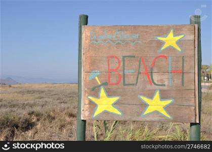 beach wooden sign at Kos island, Greece (blue sky background)