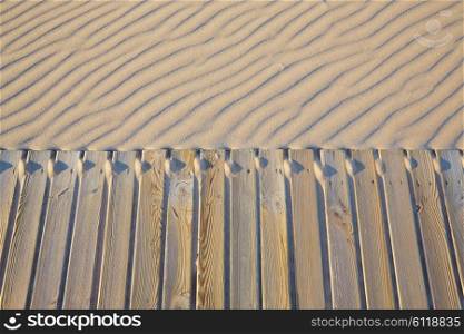 Beach wooden walkway and sand dunes texture wavy in Mediterranean