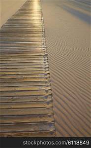 Beach wooden walkway and sand dunes texture wavy in Mediterranean