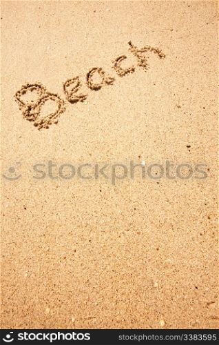 Beach written in the sand on the coast