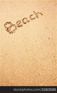 Beach written in the sand on the coast