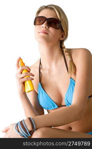 Beach - Young woman in bikini with sunglasses apply suntan lotion
