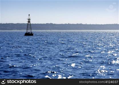 Beacon floating on blue ocean as navigation guide help