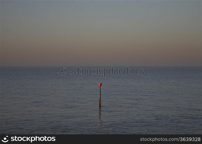 Beacon in ocean at dusk