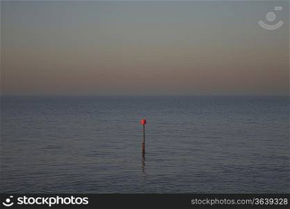 Beacon in ocean at dusk