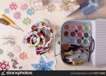 Beaded, box with colored beads and tools for creating jewelry. Preparation for handmade