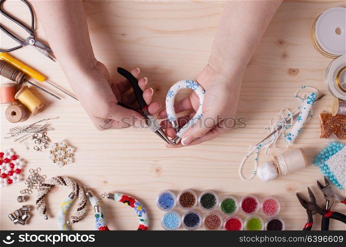 Beads and tools for creating jewelry. Preparation for handmade. Top view. Handmade beading preparation