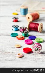 Beads,thread and bobbins for needlework.Picture in light key