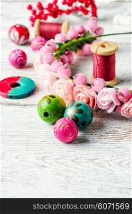 Beads,thread and other sewing accessories in the manufacture of ornaments wreath on his head