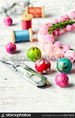 Beads,thread and other sewing accessories in the manufacture of ornaments wreath on his head