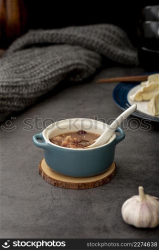 bean soup blue jar with garlic grey background