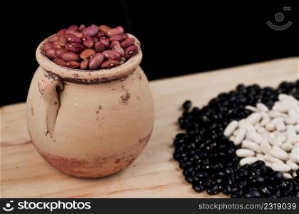 Beans and vegetables on wooden board