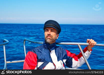 Beard sailor man sailing sea ocean in a boat with captain cap looking horizon