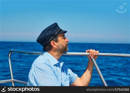 Beard sailor man sailing sea ocean in a boat with captain cap looking horizon