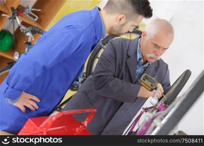bearded caucasian man repairing the mtb bicycle