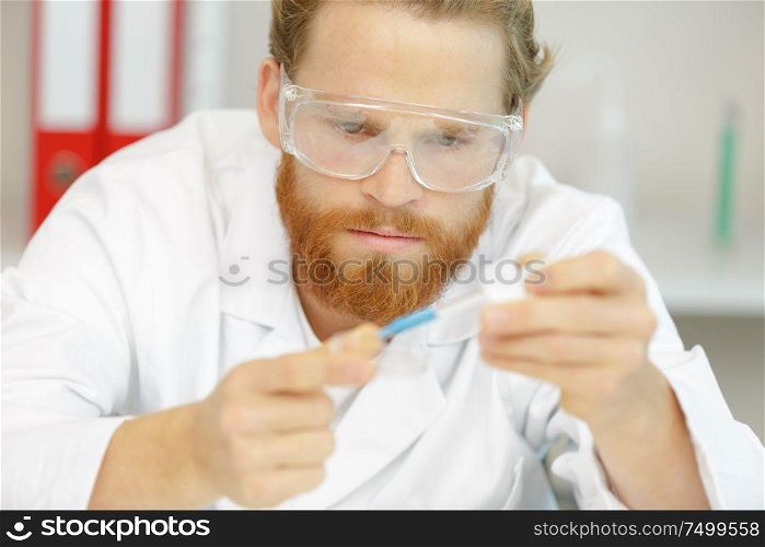bearded male scientist working in laboratory