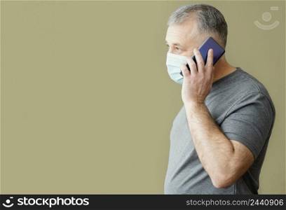 bearded man with surgical mask using phone 2
