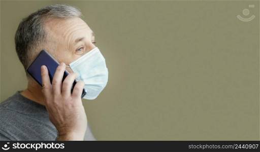 bearded man with surgical mask using phone 3