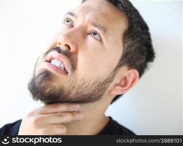 Bearded thirty-year old man has pain in his throat.