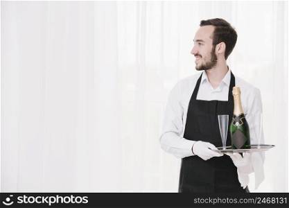 bearded waiter with tray looking away