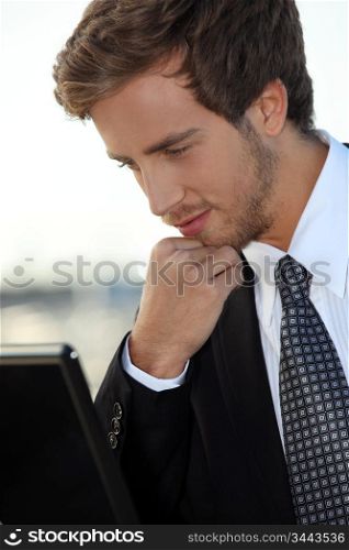 Bearded young exec with a laptop computer