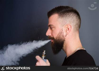 beared man smoking electronic cigarette