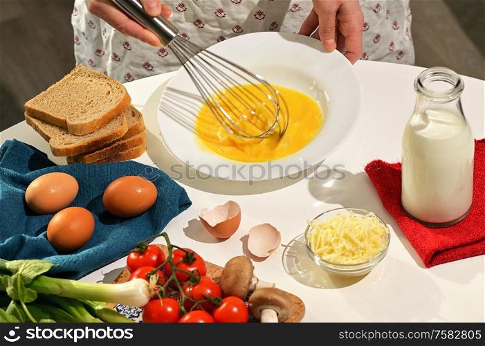 Beaten Raw Eggs to Prepare An Omelette