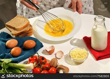 Beaten Raw Eggs to Prepare An Omelette