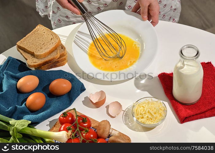 Beaten Raw Eggs to Prepare An Omelette