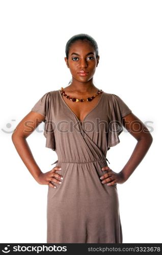 Beatiful African American business woman standing with hands on hips wearing a gray fashion dress and amber necklace, isolated.
