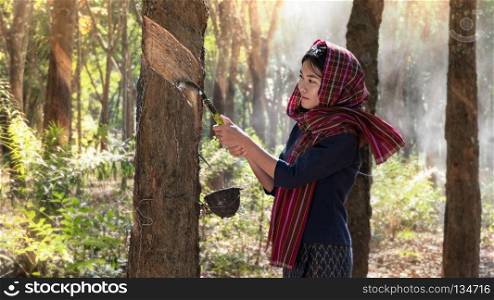 Beatiful asian woman smile in rubber plantation , Thailand. woman  in rubber plantation 