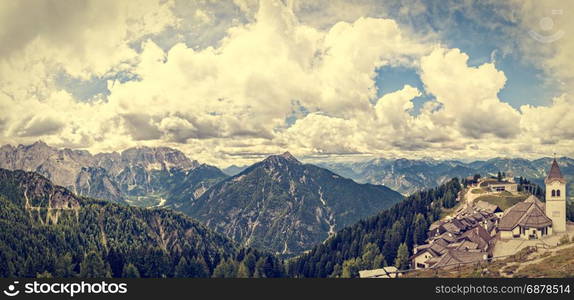 Beatifull mountain landscape with typical village ,church and belfry. Monte Lussari Italy