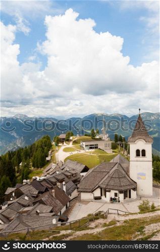 Beatifull mountain landscape with typical village ,church and belfry. Monte Lussari Italy