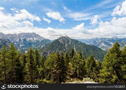 Beatifull mountain panorama with forest, blue sky and clouds. Italian Alps.