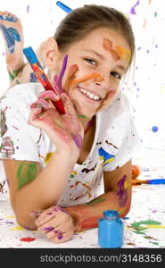 Beatutiful 9 year old girl covered in colorful paints.