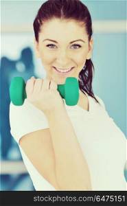 beaudiful young woman fitness workout with weights at sport club. woman fitness workout with weights