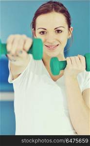 beaudiful young woman fitness workout with weights at sport club. young woman fitness workout
