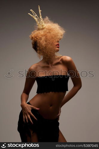 beaut, glamour and helloween concept - woman with long curly hair in crown