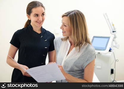 Beautician Discussing Treatment With Female Client