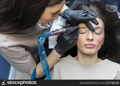 beautician doing eyebrow treatment her client_3. beautician doing eyebrow treatment her client_2