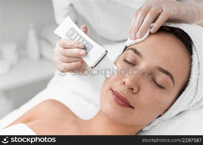beautician doing face beauty routine female client