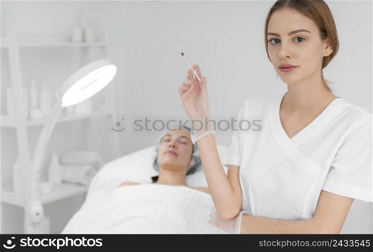 beautician doing injection filler female client salon 2