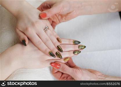Beautician is doing manicure to her costumer. nail treatment