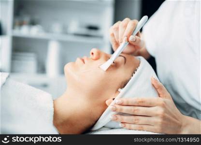 Beautician makes rejuvenation procedure to female patient, cosmetology clinic. Facial skincare in spa salon, health care. Beautician makes rejuvenation procedure to patient