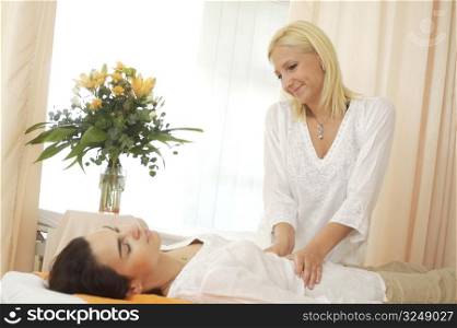 Beautician massages a patient in the beauty salon.