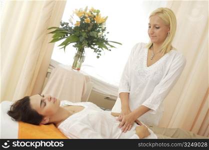 Beautician massages a patient in the beauty salon.