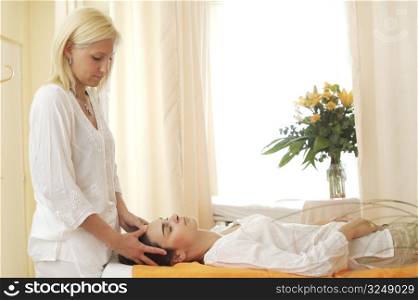 Beautician massages patient in the beauty salon.