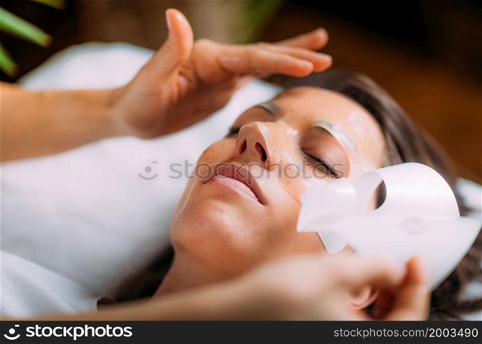 Beautician Putting Beauty Face Mask on Woman&rsquo;s Face